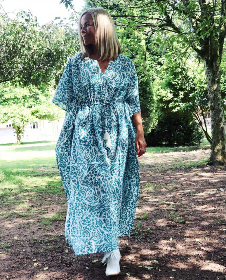 Woman walking outdoors wearing Eden bohemian printed cotton teal maxi kaftan//dress free size with a relaxed fit and intricate boho style patterns.