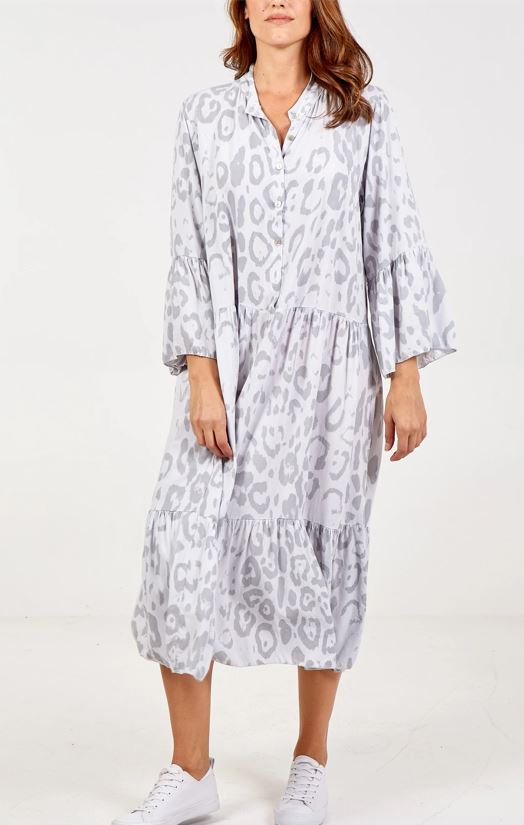 Woman wearing Paloma animal-print boho midi smock dress free-size in soft gray tones, featuring relaxed fit, flared sleeves, and tiered skirt, styled with white sneakers.
